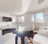 Living room with white furniture, a television, and a glass table in a 5 or more room apartment.