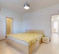 A bedroom with a double bed and a built-in wardrobe in a 5 or more room apartment.