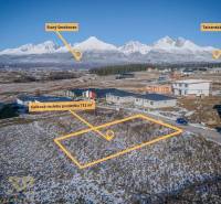 Winter landscape in Mlynica with residential plots, featuring a panoramic mountain view.