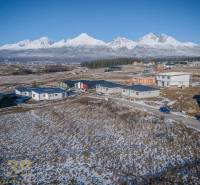 Snow-covered residential plots in Mlynica with panoramic mountain views.
