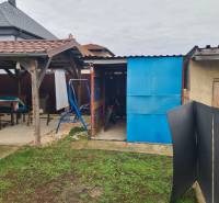 The garden of a family house in Hurbanovo, gazebo, shed, bicycle, swing, lawn area.