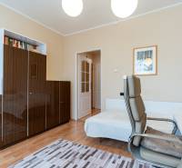 A study in a 4-room apartment with a wooden decor floor and light-colored furniture.