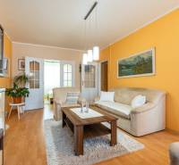 Living room with a sofa, coffee table, and wooden decor flooring in a 4-room apartment.