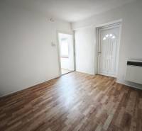 Interior of a family house with a wooden decor floor and white walls.