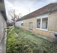 A family house in Lúčnica nad Žitavou with wooden cladding and a garden.