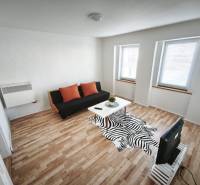 Living room in a family house with a sofa, table, and floor with a wooden decor.