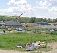 Plots - housing in Modrovka; visible unfinished houses and building materials.