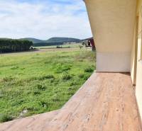 A family house in Buková with a terrace and a wooden decor floor, overlooking the fields.