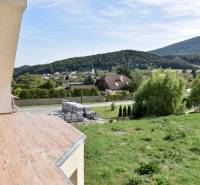View from a family house in Buková to the hilly landscape, with a wooden decor floor.