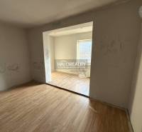 A room in a family house with a wooden decor floor and inscriptions on the walls.