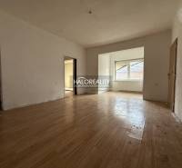 Interior of a family house with a wooden decor floor and a large window.