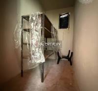 Narrow storage room with shelves and plastic wrap in a family house.