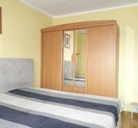 Bedroom with a bed, wardrobe, and decoration in a 3-room apartment.