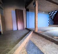 Attic space in a family house with wooden elements, checkerboard wall.