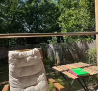 Relax on the terrace of a house in Bratislava - Vrakuňa with a lounger and a table under the blue sky.
