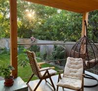 A terrace with garden furniture and greenery in a 4-room apartment in Bratislava - Vrakuňa.