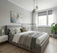 A bright bedroom with a comfortable bed, wood-decorated floor, hanging lamps, plant.