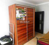 A kitchen with wooden decor and stone cladding in a 2-room apartment.