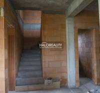 Staircase and bricks in a family house during construction, without plaster and finishing.