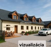A family house in Tibava with a terrace, a car in front of the garage, and garden furniture.