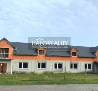 The building in Tibava designated for commercial spaces has unfinished exterior modifications.