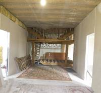 Interior of commercial premises with a wooden staircase and carpet.
