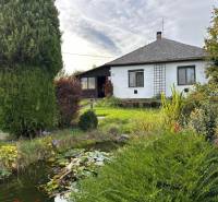 A family house in Kalša with a beautiful garden and a small pond surrounded by greenery.