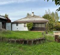 A family house in Kalša with a large garden, grass, and wooden elements in the exterior.