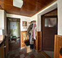 Interior of a family house with entrance to the bathroom and coat hooks.