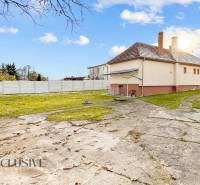 A family house on Nemečkovská Street in Prašice with a large yard and a sheet metal fence.