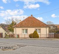 A family house in Prašice on Nemečkovská Street with a fence and a sloped roof.