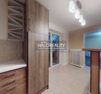A kitchen in a 2-room apartment with a wooden decor floor and modern lighting.