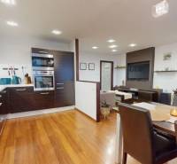 Kitchen and dining room in a 3-room apartment with a wooden decor floor.