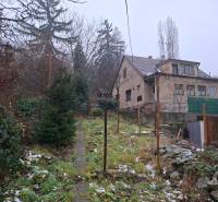 A family house on Búdková Street in Bratislava - Staré Mesto, surrounded by a snowy garden.