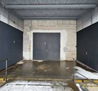 Three garage doors with metal fencing at the Offices in Poprad.