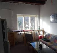 Living room with a couch and a view outside, Family house with simple furnishings.