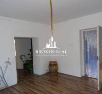 Living space in a family house with a wooden decor floor and white walls.