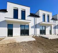 A family house on Polnokesovska Street in Mojmírovce with large windows and an undeveloped yard.