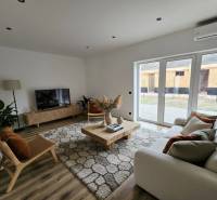 Living room in a family house with a wooden decor floor and elegant furniture.