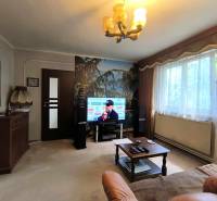 Living room with a television, sofa, table, and large window, Family house.