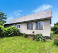 A family house in Nováky with a garden, lawn, and ornamental shrubs.