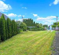 Garden area of a family house in Prievidza with a carefully maintained lawn and hedge.