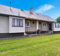 A family house in Nováky with a large grassy area and simple architecture.