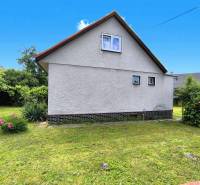 A family house in Nováky with a garden, lawn, and flowers in a pleasant environment.