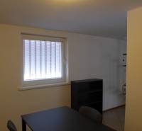 Office space with a desk and shelf, warehouses and halls, bright atmosphere.