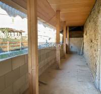 Built-up area of a family house in Hronec with stone walls and wooden beams.