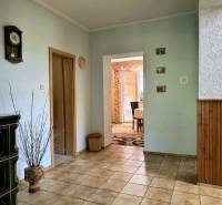Interior of a family house with ceramic tiles, decorative cladding, and a ceramic stove.