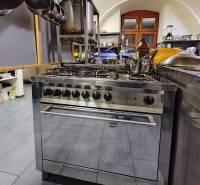 A kitchen with a gas stove and equipment in catering premises.