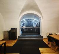 Interior of gastro spaces with vaults, chalkboard walls, and flooring with wood decor.