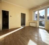 A room in a 5 or more bedroom apartment with sunlight and a wooden decor floor.